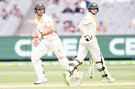 Australia's batsmen Mitchell Marsh (L) and Steve Smith (R) take runs from the England bowling on final day of the fourth Ashes cricket Test match at the MCG in Melbourne on December 30, 2017.	photo: AFP 