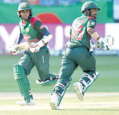 Bangladesh batsman Liton Das (R) and Mehidy Hasan Miraz run between the wickets during the final one day international (ODI) Asia Cup cricket match between Bangladesh and India at the Dubai International Cricket Stadium in Dubai on Friday. 	photo: AFP 
