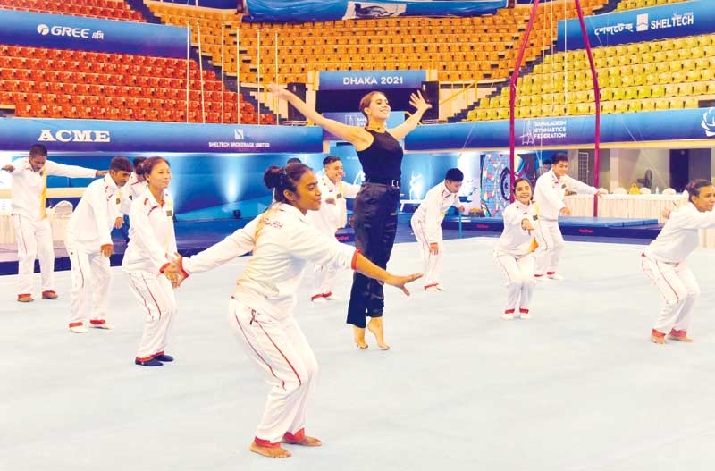 Bangladesh gymnasts along with Rio Olympic gold medallist gymnast Margarita Mamun doing warm-up on Tuesday at Shaheed Suhrawardy National Indoor Stadium in Mirpur