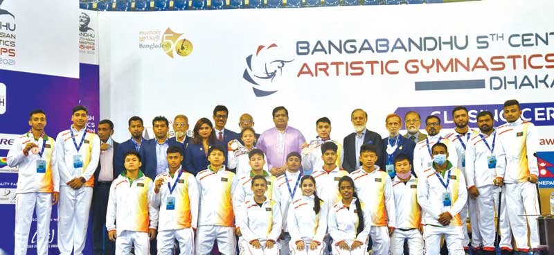The Bangladeshi participants at the award programme of Bangabandhu 5th Central South Asian Artistic Gymnastics Championship 2021 with the State Minister for Youth and Sports Zahid Ahsan Russel, Bangladesh Gymnastics Federation (BGF) president Sheikh Bashir Ahmed Mamun, general secretary Ahmedur Rahman Bablu and other officials at Shaheed Suhrawardy National Indoor Stadium in Mirpur, Dhaka on Sunday.	photo: Courtesy 