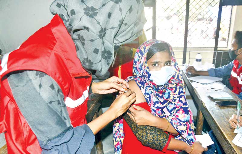 A woman receives the jab on the spot. 	PHOTO: OBSERVER