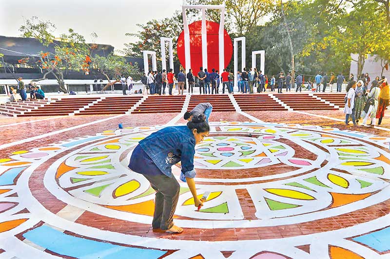 The Alpana on the floor of the Central Shaheed Minar gets a finishing touch on Saturday ahead of the Shaheed Dibash and International Mother Language Day on Monday. 	PHOTO: OBSERVER