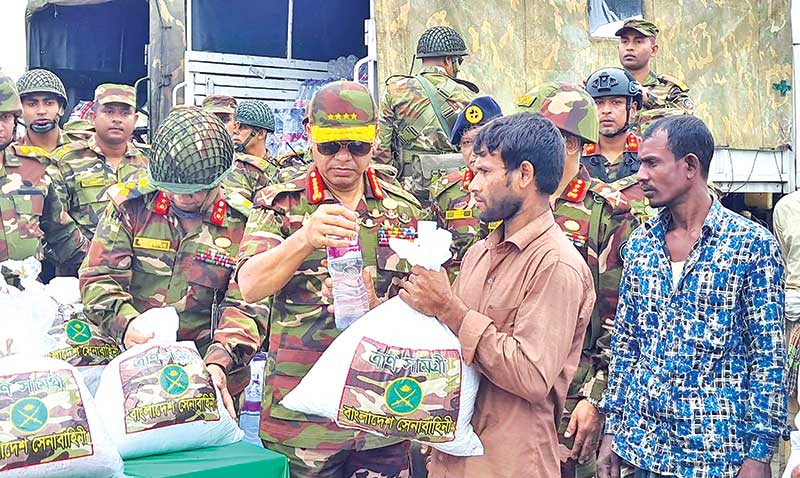The Army Chief Gen SM Shafiuddin Ahmed distributes relief items among the flood victims of Companiganj upazila in Sylhet on Sunday. 	photo : ispr