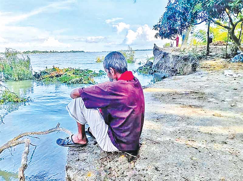 The picture taken recently shows an old man who became destitute losing his house and land because of the Meghna erosion at Mahishberh Village in Charsubuddhi under Raipur Upazila of Narsingdi District.	photo: observer