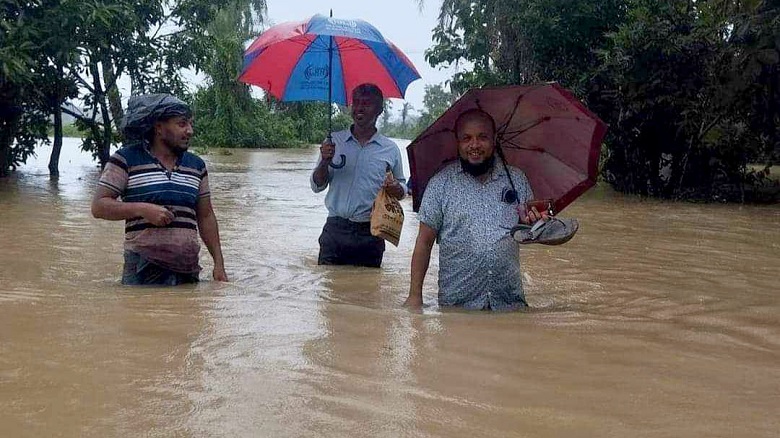 Pedestrians are wading through knee deep water in many places of Feni district. Photo: Collected