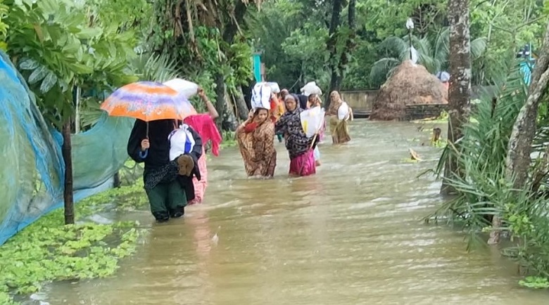 People of Noakhali district were seen wading through knee-deep and sometimes waist-deep water to reach their destination. Photo: Observer