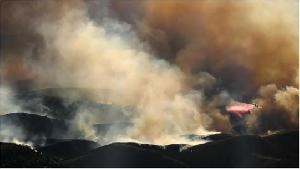 Air tankers fight Los Angeles fires from frantic skies