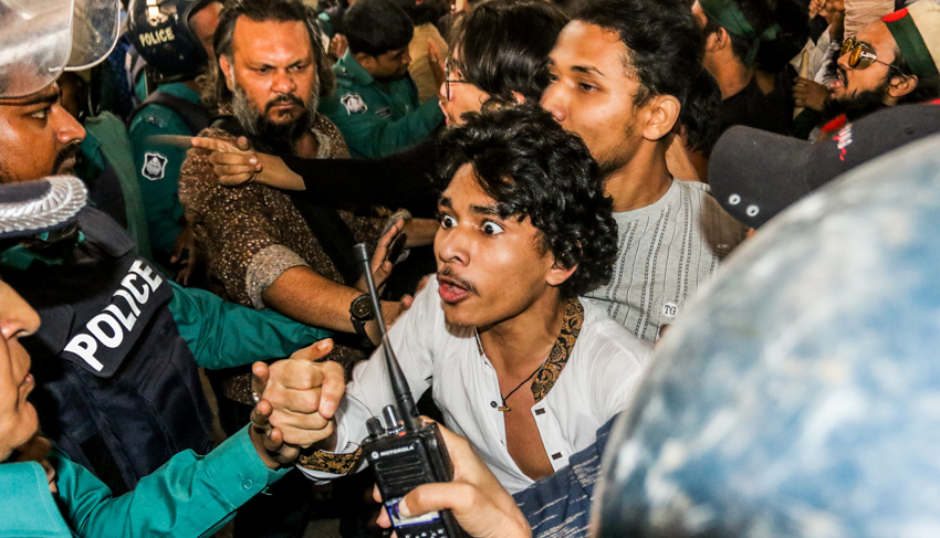 A protester was seen locked into an altercation with police. Photo: Sumit Ahmed