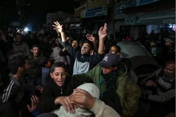 Palestinians celebrate the announcement of a ceasefire deal between Hamas and Israel in Deir al-Balah, central Gaza Strip, on January 15, 2025.