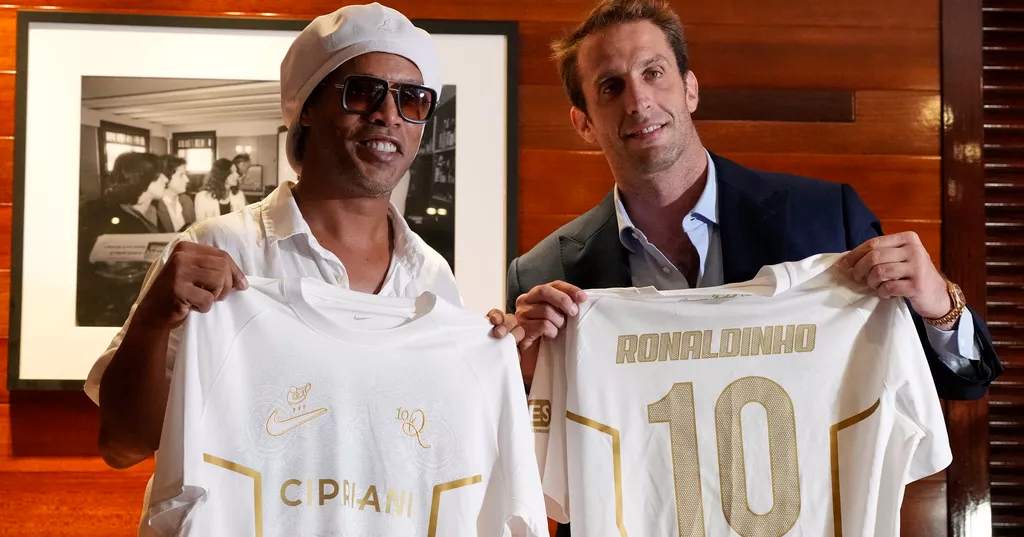 Brazilian football legend Ronaldinho (L) holds up jerseys along with Ignazio Cipriani, president of Ravenna FC, at a media event celebrating Ronaldinho’s recent signing with the Italian soccer club, at Cipriani Downtown Miami restaurant on Tuesday. (AP Photo/Rebecca Blackwell)