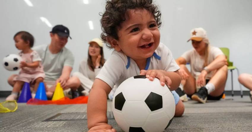 Ten-month-old Zain Fawaz plays with a soccer ball at a program introducing toddlers to the sport ahead of the World Cup soccer tournament Thursday, June 4, 2026, in Lenexa, Kan. (AP Photo)