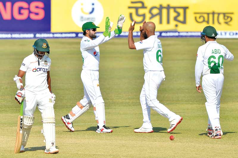 Pakistan's Sajid Khan (2R) celebrates with teammate Mohammad Rizwan (2L) after taking the wicket of Bangladesh's Taijul Islam on the fourth day of the first Test cricket match between Bangladesh and Pakistan at the Zahur Ahmed Chowdhury Stadium in Chittagong on November 29, 2021.	photo: AFP 