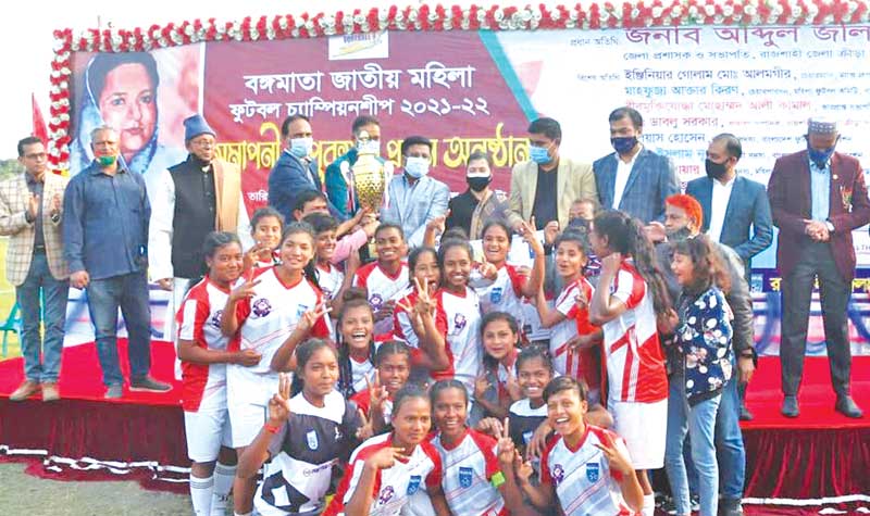 Rajshahi booters celebrating the champions' trophy of the Bangamata National Women's Football Championship 2021-22 on Saturday at Shaheed Muktijoddha Smriti Stadium in Rajshahi. 	photo: BFF 