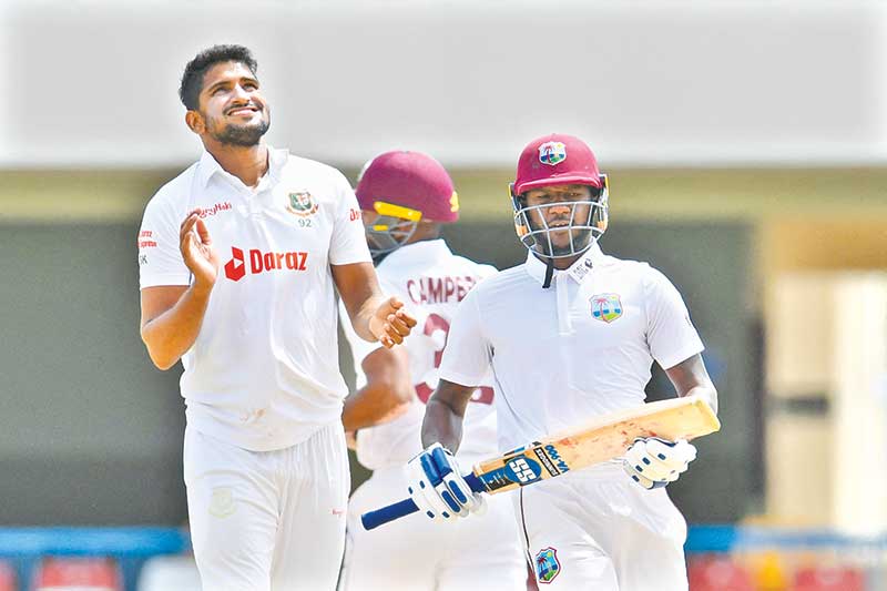 Syed Khaled Ahmed (L), of Bangladesh, expresses disappointment as Jermaine Blackwood (R), of West Indies, runs during the fourth day of the 1st Test between Bangladesh and West Indies at Vivian Richards Cricket Stadium in North Sound, Antigua and Barbuda, on June 19, 2022. 	photo: AFP 