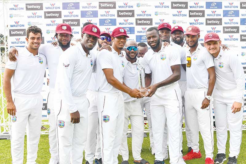 Members of the West Indies team stand for a photo with the trophy after winning on the fourth day of the 2nd Test between Bangladesh and West Indies at Darren Sammy Cricket Ground in Gros Islet, Saint Lucia, on June 27, 2022. 	photo: AFP 