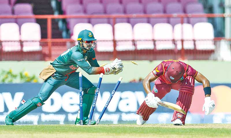 Shai Hope (R) of West Indies is dismissed by Quazi Nurul Hasan Sohan (L) of Bangladesh during the 3rd and final ODI match between West Indies and Bangladesh at Guyana National Stadium in Providence, Guyana, on July 16, 2022.	photo: AFP 