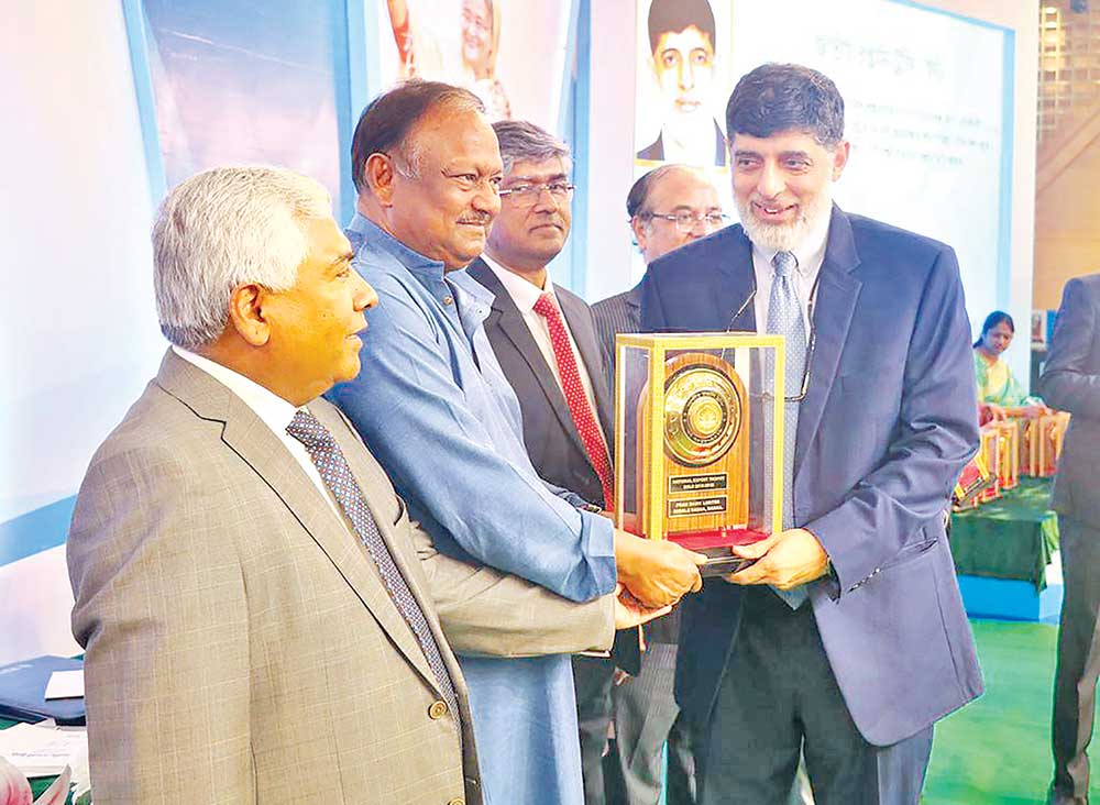Minister for Commerce Tipu Munshi handing over a trophy to Ahsan Khan Chowdhury, Chairman and CEO of PRAN-RFL Group for its outstanding contribution to export segment for FY 2018-19,  at a national award giving ceremony  at Bangabandhu Bangladesh-China Friendship Exhibition Center at Purbachal on Tuesday.
