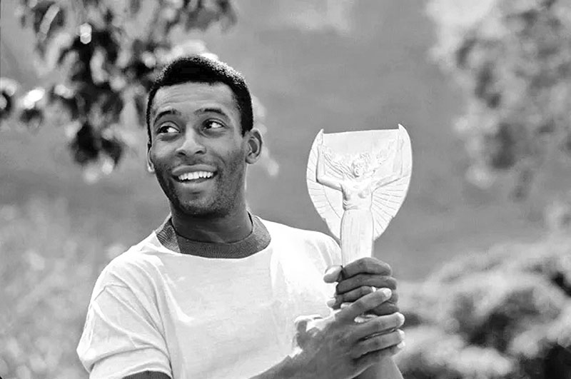 Pele pictured with the Jules Rimet trophy in 1970. A replica of the trophy that he was given will be auctioned.	photo: Courtesy 