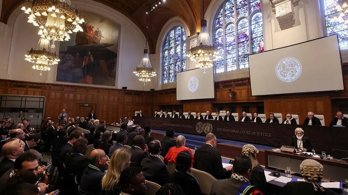 People sit inside the ICJ on the day of the trial to hear a request for emergency measures by South Africa, who asked the court to order Israel to stop its military actions in Gaza, in The Hague, Netherlands, on January 11, 2024. (Reuters)