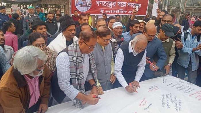 BNP senior leader Dr Abdul Moyeen Khan signs at a mass signature collection campaign arranged by Nagorik Oikya in front of Jatiya Press Club in the capital on Saturday 