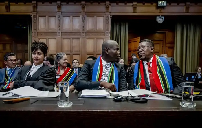 Justice Minister Ronald Lamola (middle) and Vusimuzi Madonsela (right), South Africa's ambassador to the Netherlands, at the International Court of Justice before the hearing of the genocide case against Israel in The Hauge on 11 January 2024. (Photo: EPA-EFE / Remko de Waal) 