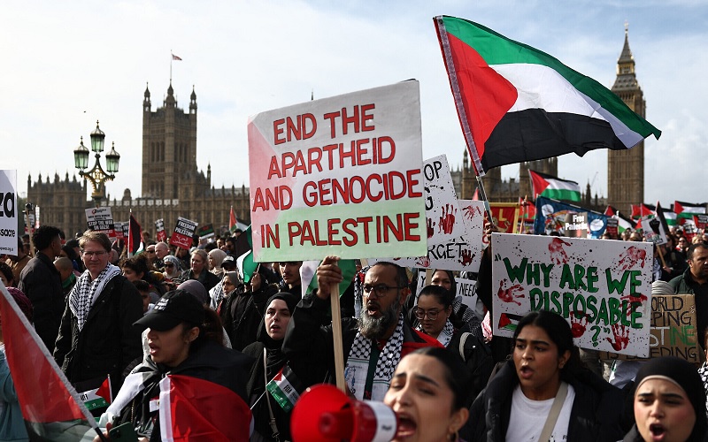 Protesters hold placards and wave Palestinian flags during a 'March For Palestine' in London on October 28, 2023, as they call for ceasefire in the war between Israel and Hamas. (Henry Nicholls/AFP)