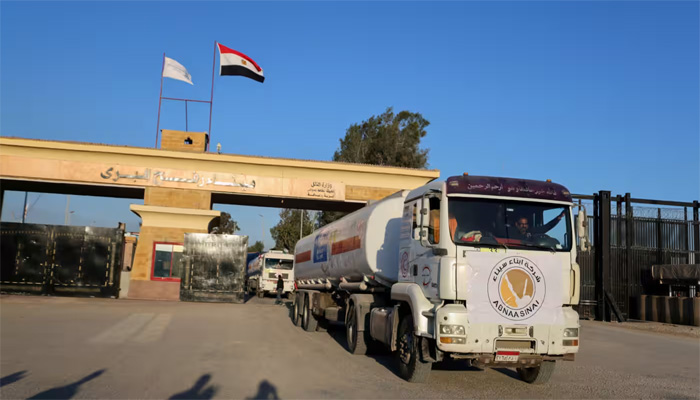 A truck marked with United Nations Relief and Works Agency (UNRWA) logo crosses into Egypt from Gaza on November 30.   © Reuters 