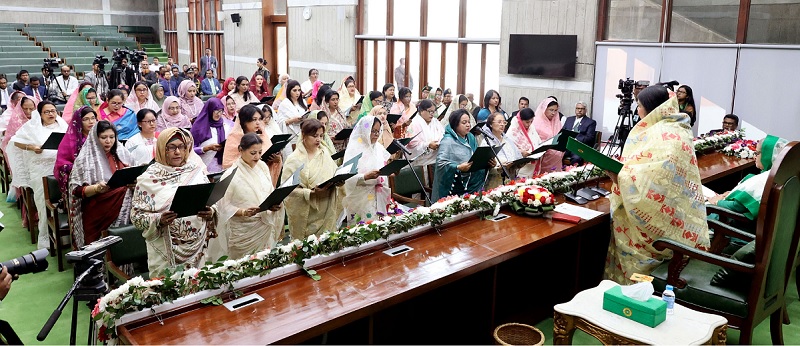 In presence of Prime Minister Sheikh Hasina (sitting left), Jatiya Sangsad Speaker Shirin Sharmin Chaudhury administers oath to members of parliament (MPs) elected uncontested to 50 reserved seats of women on Wednesday (February 28, 2024) afternoon.