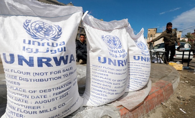 Displaced Palestinians wait to receive United Nations Relief and Works Agency (UNRWA) aid, amid the ongoing conflict between Israel and the Palestinian Islamist group Hamas, in Rafah. (File/Reuters)