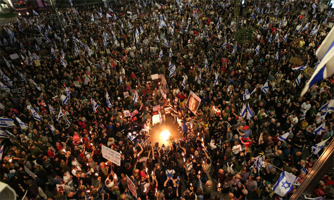 Demonstrators light a fire at Kaplan Street as thousands of Israeli citizens stage a demonstration demanding Benjamin Netanyahu's resignation, early elections and release of Israeli hostages in Gaza. Photograph: Anadolu/Getty Images