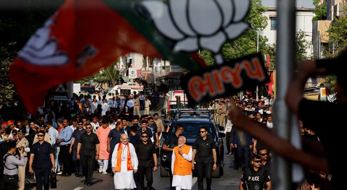 Narendra Modi shows his ink-marked finger after voting at a polling station during the third phase of the general election, in Ahmedabad, India, on May 7.