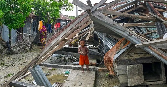 A child stands by his destroyed house in Patuakhali on May 28. Cyclone Remal, which made landfall in low-lying Bangladesh and neighboring India on May 26 left at least 31 people dead, destroyed thousands of homes, smashed seawalls and flooded cities across the two countries. (Photo: AFP)