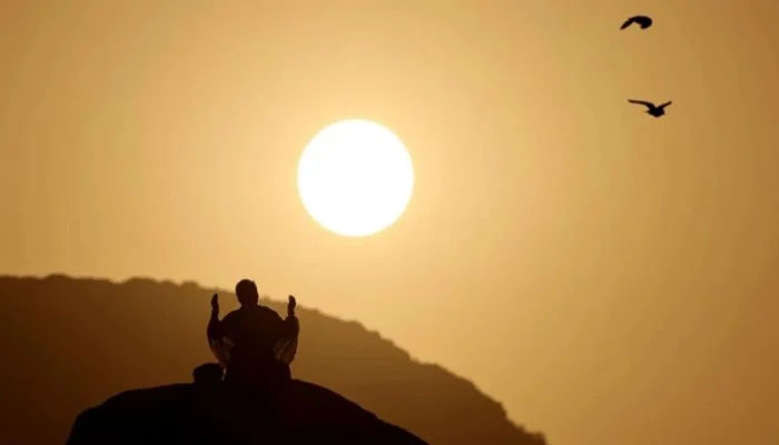 A Muslim pilgrim prays at dawn on Saudi Arabia's Mount Arafat, also known as Jabal al-Rahma or Mount of Mercy, during the climax of the Hajj pilgrimage on Saturday. AFP Photo