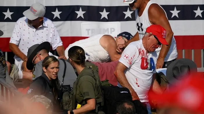 Audience members duck in the crowd during a shooting attempt at a campaign rally for Republican presidential candidate, former US President Donald Trump at Butler Farm Show Inc. on July 13, 2024 in Butler, Pennsylvania. (AFP)