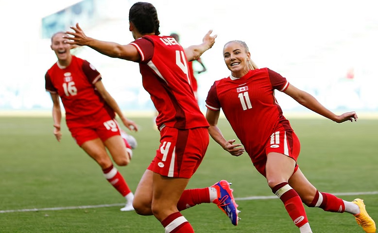 Evelyne Viens of Canada celebrates scoring their second goal with Adriana Leon of Canada. Photo: REUTERS