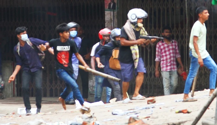 Students clash with ruling Awami League's student wing Chhatra League and youth wing Jubo League in Chittagong on Sunday. The photo shows that a Jubo League activist waering helmet firing at students at Tinpoler Mukh in the port city.