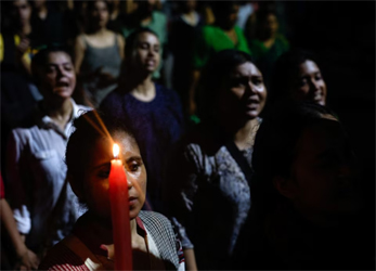 A woman holds a candle as she attends a candlelight vigil held outside Jadavpur University campus, condemning the rape and murder of a trainee medic at a government-run hospital in Kolkata, India, August 15, 2024. File Photo: REUTERS