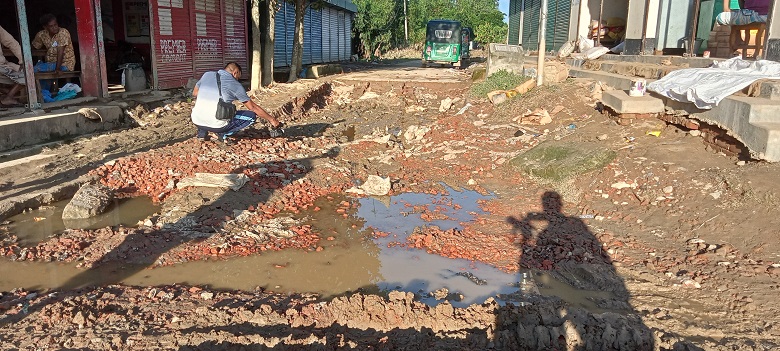 Floodwater creates potholes in a road at Kalikapur village under Mirjapur union of Parshuram upazila of Feni. Photo: Observer