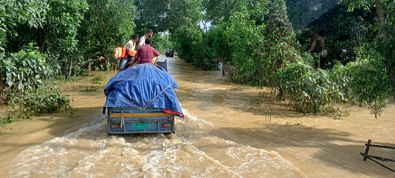 A goods-laden truck heading towards Parshuram to distribute relief among the flood victim. Photo: Observer