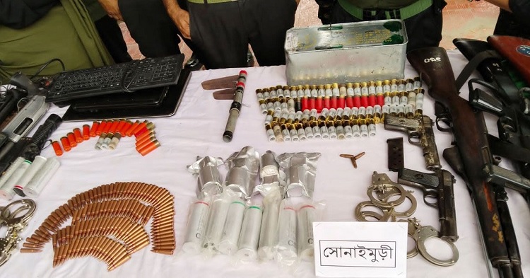 Arms and ammunition looted from Sonaimuri in Noakhali district during the recent violence. FILE PHOTO