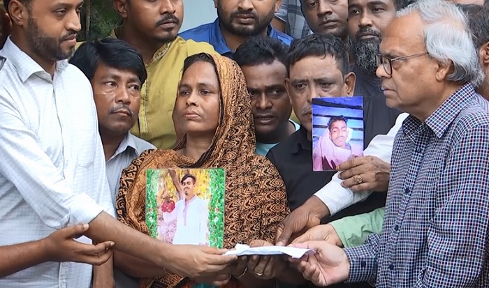 BNP Joint Secretary General Ruhul Kabir Rizvi visits the house of rickshawpuller Sagar at Rampura in the capital on Friday afternoon and hands over some assistance to the family. Sagar's mother seen holding a large portrait of her son.