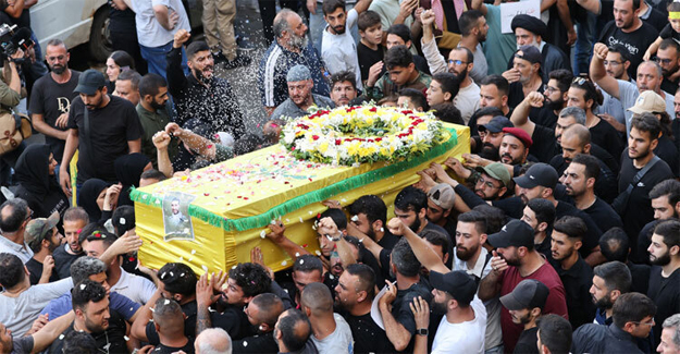 Mourners toss rice over the coffin of person a killed after hundreds of paging devices exploded in a deadly wave across Lebanon the previous day, during a funeral procession in Beirut's southern suburbs on September 18, 2024. - AFP Photo