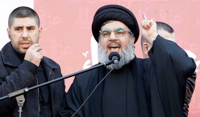 In this file photo, taken on December 6, 2011, Hezbollah leader Hassan Nasrallah speaks to the crowd in a rare public appearance during a rally to mark the Muslim holy day of Ashoura, in Beirut’s southern suburbs. (AP/File)