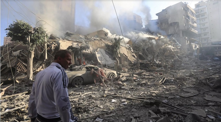 A man walks amid the rubble of a building levelled in an Israeli air strike that targeted the neighbourhood of Moawad in Beirut's southern suburbs PHOTO: AFP 