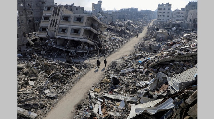 Palestinians walk past destroyed houses, amid the ongoing conflict between Israel and Hamas, in Jabalia refugee camp, in the northern Gaza Strip. (File/Reuters)