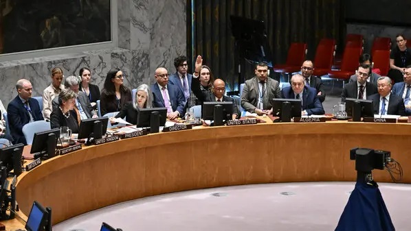 Robert A. Wood, the American ambassador to the U.N., raising his hand to veto a draft resolution calling for a cease fire in Gaza, on Wednesday at UN headquarters in New York PHOTO: AFP