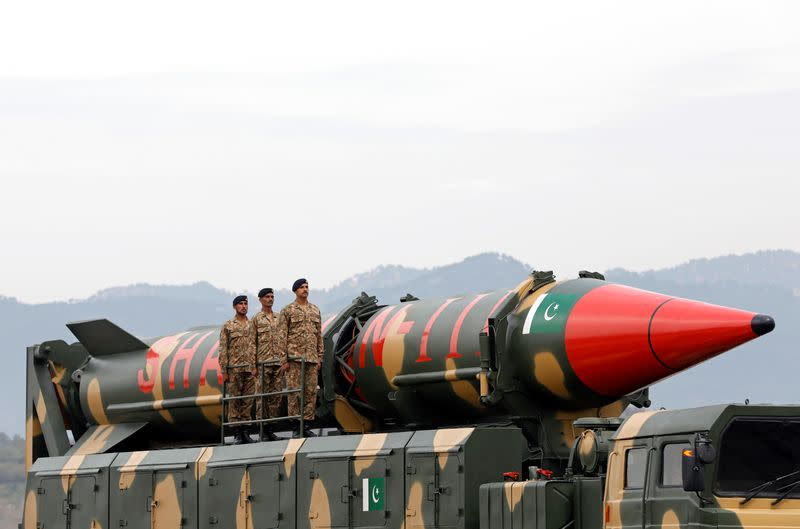 FILE PHOTO: Pakistani military personnel stand beside a Shaheen III surface-to-surface ballistic missile during Pakistan Day military parade in Islamabad