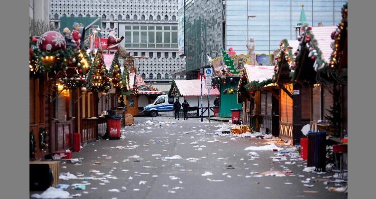 Police officers walk through a cordoned-off Christmas Market, where a car drove into a crowd in Magdeburg, Germany, Dec. 21, 2024. (AP Photo/Ebrahim Noroozi)