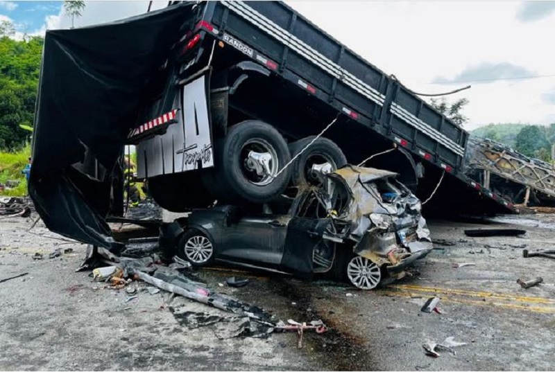 A car is crushed after a packed bus collided with a truck on the Fernao Dias national highway near Teofilo Otoni, Brazil.