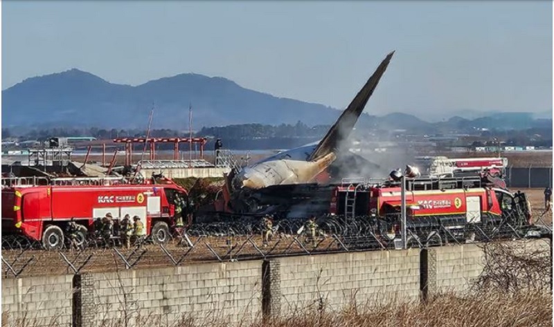 The tail section of a Jeju Air Boeing 737-800 series aircraft is seen beside rescue vehicles after the plane crashed and burst into flames at Muan International Airport in South Jeolla Province, some 288 kilometres southwest of Seoul on December 29, 2024